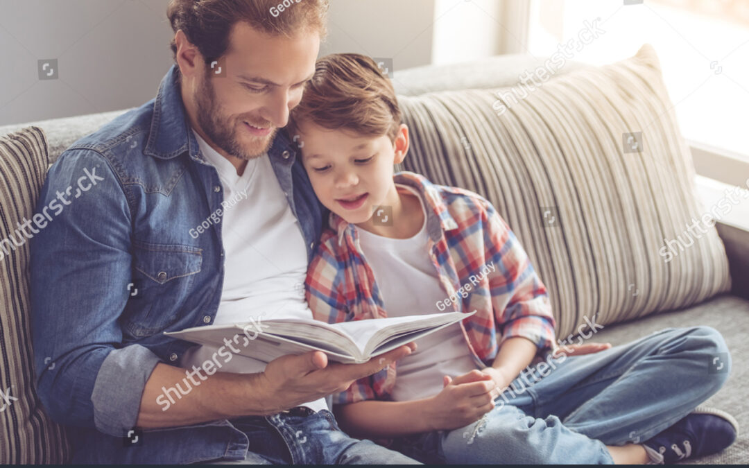 stock-photo-father-and-son-are-reading-a-book-and-smiling-while-spending-time-together-at-home-523948348